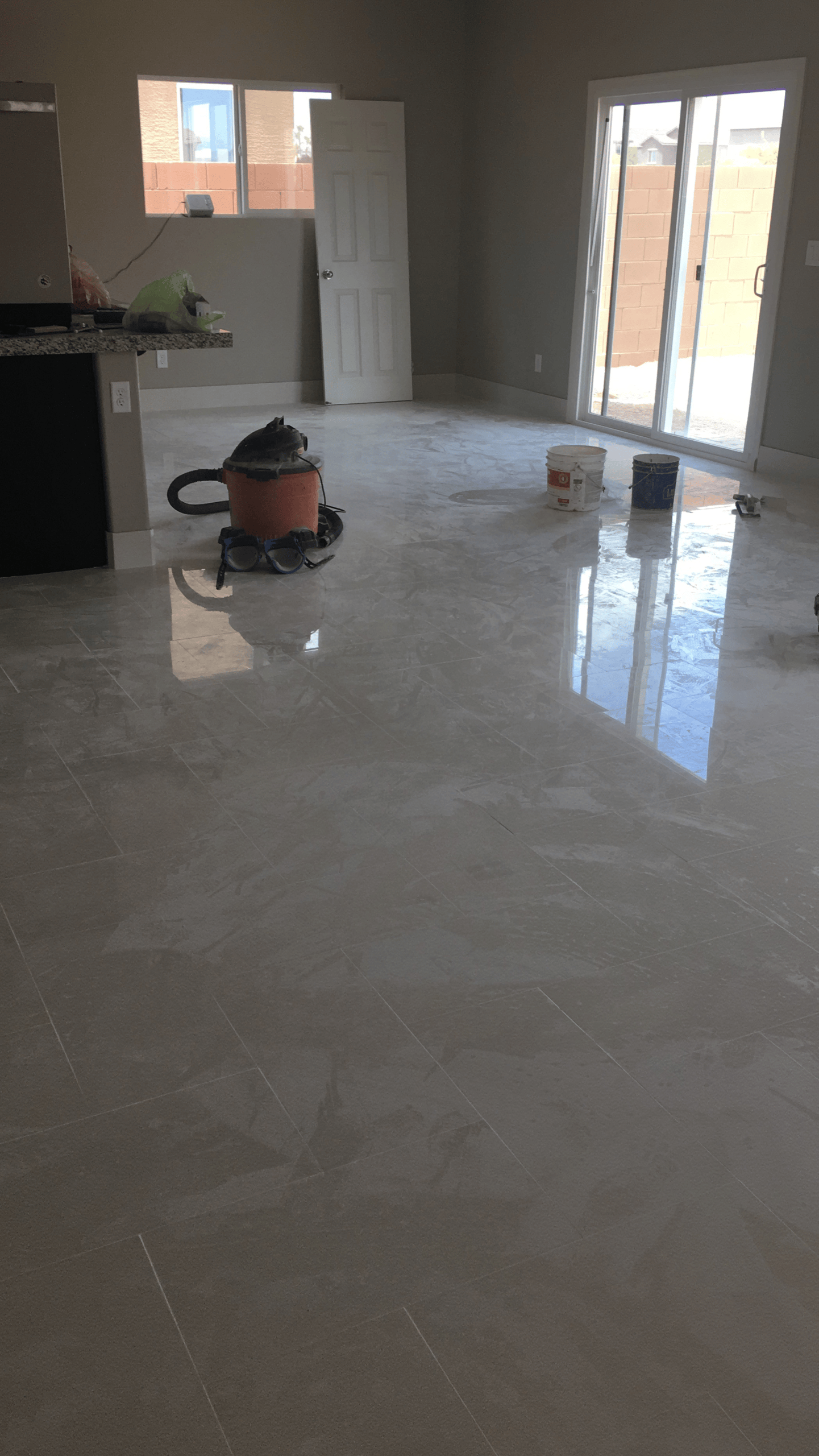 Large-format tile flooring beside a kitchen peninsula