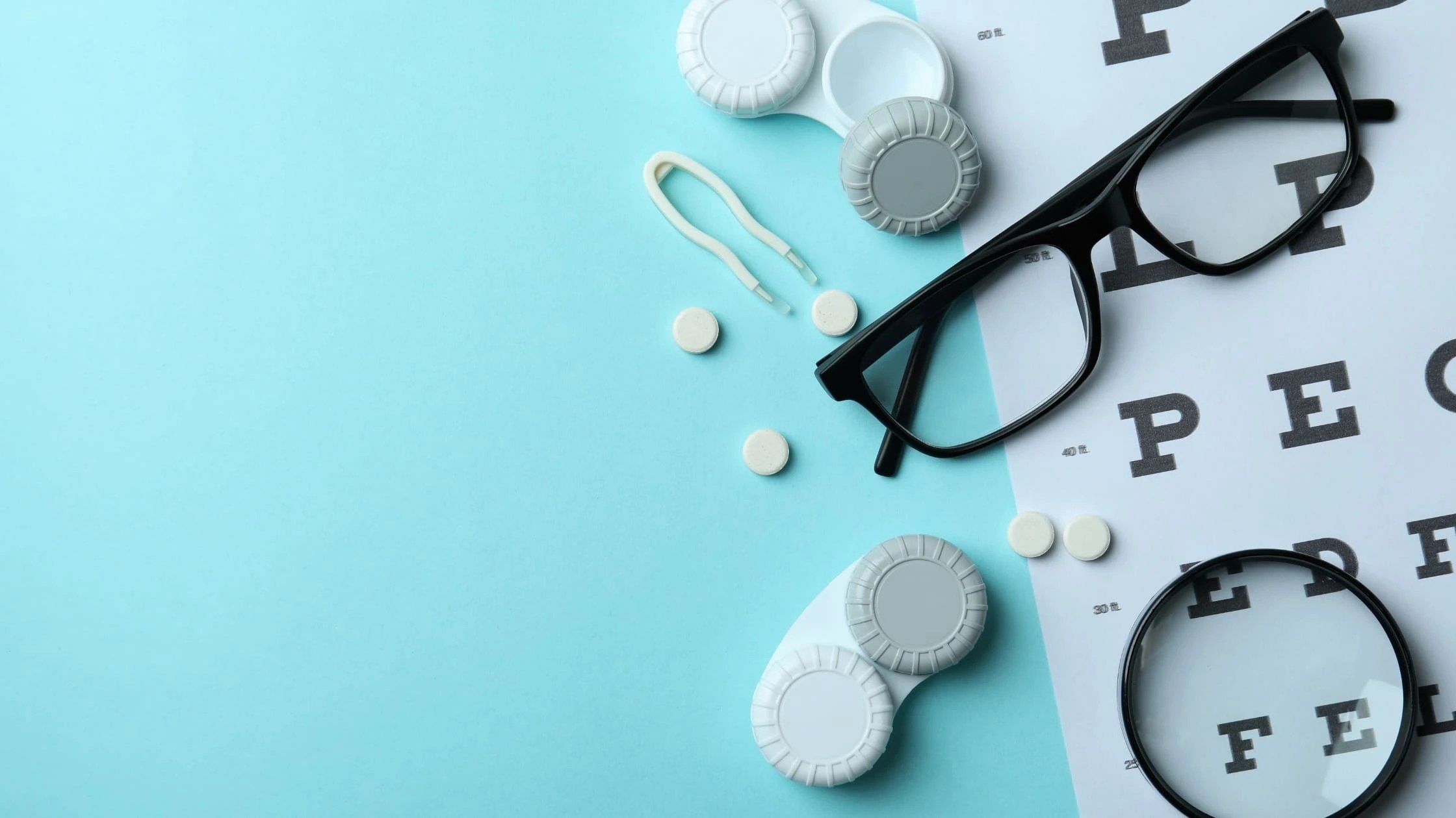 an image showing a spectacles an eye checkup chart and some medicines