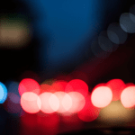 Blurred police lights at night showing red and blue emergency vehicle lighting.