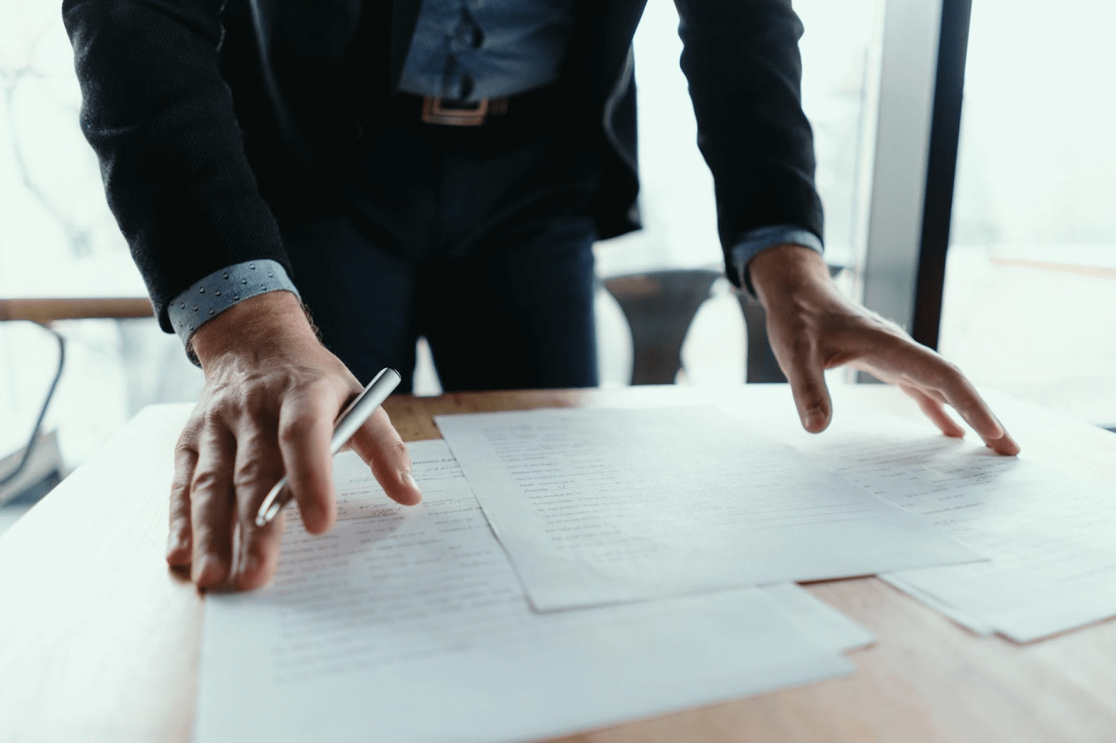 Alabama car accident lawyer reviewing legal documents and explaining when to seek legal representation after a collision.