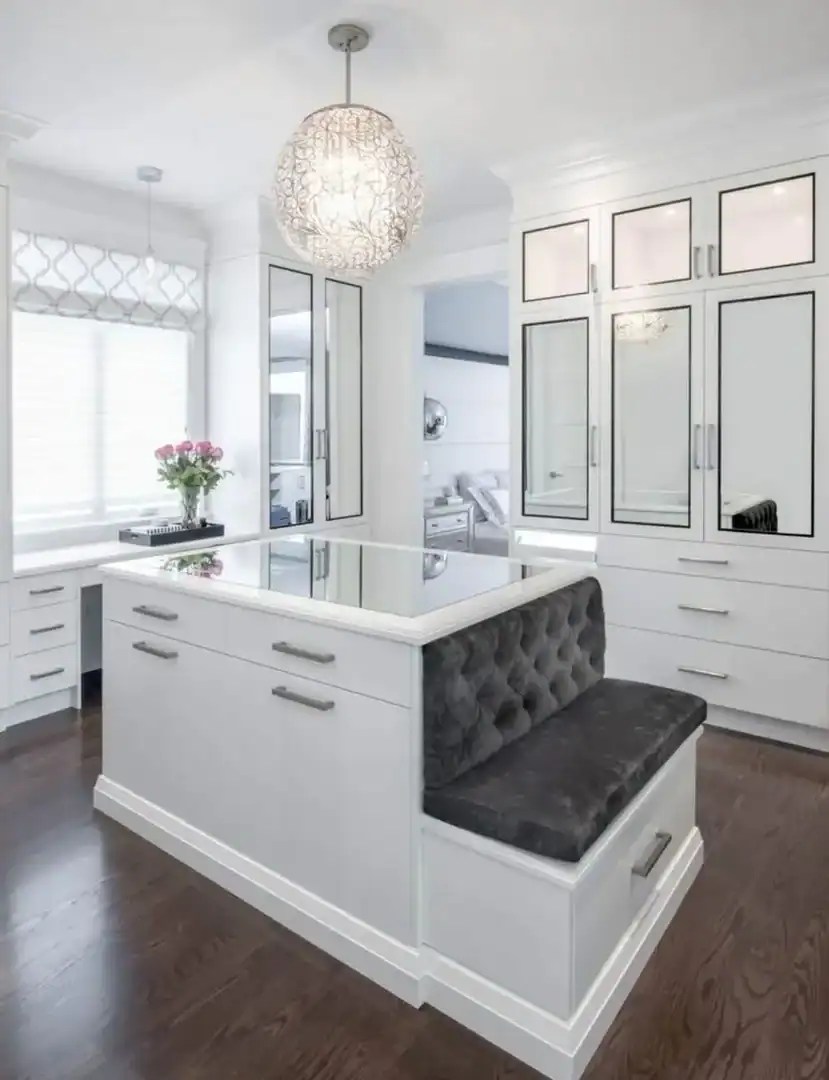 master closet with island and under window cabinets