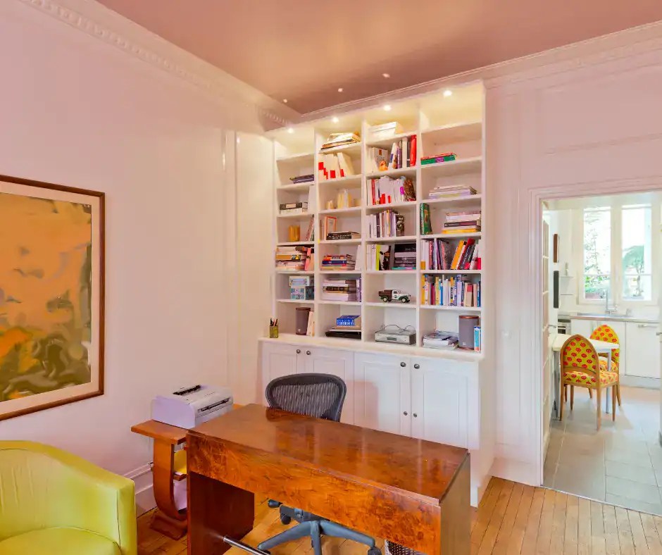 open bookshelves tucked into a wall to create a backdrop for an office