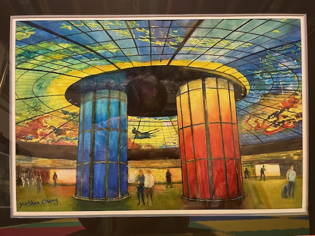 A watercolor painting by Yin Shen Chang depicting a large interior hall with a massive, vibrant stained-glass dome ceiling. Two large illuminated pillars—one vivid blue and one red-orange—stand in the center with small figures walking around the floor.