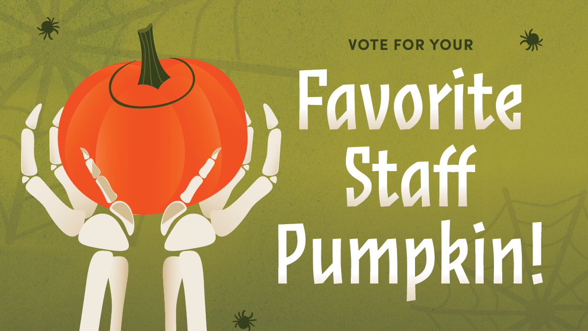 Halloween-themed graphic on an olive green background with faint spiderweb overlays. On the left, two white skeleton hands reach up to hold a round, bright orange pumpkin with a green stem. Small black spiders are scattered around the border. Text on the right reads "Vote for your Favorite Staff Pumpkin!"
