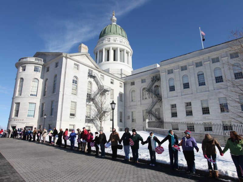 Anti-abortion protesters line outside the State House in Augusta.