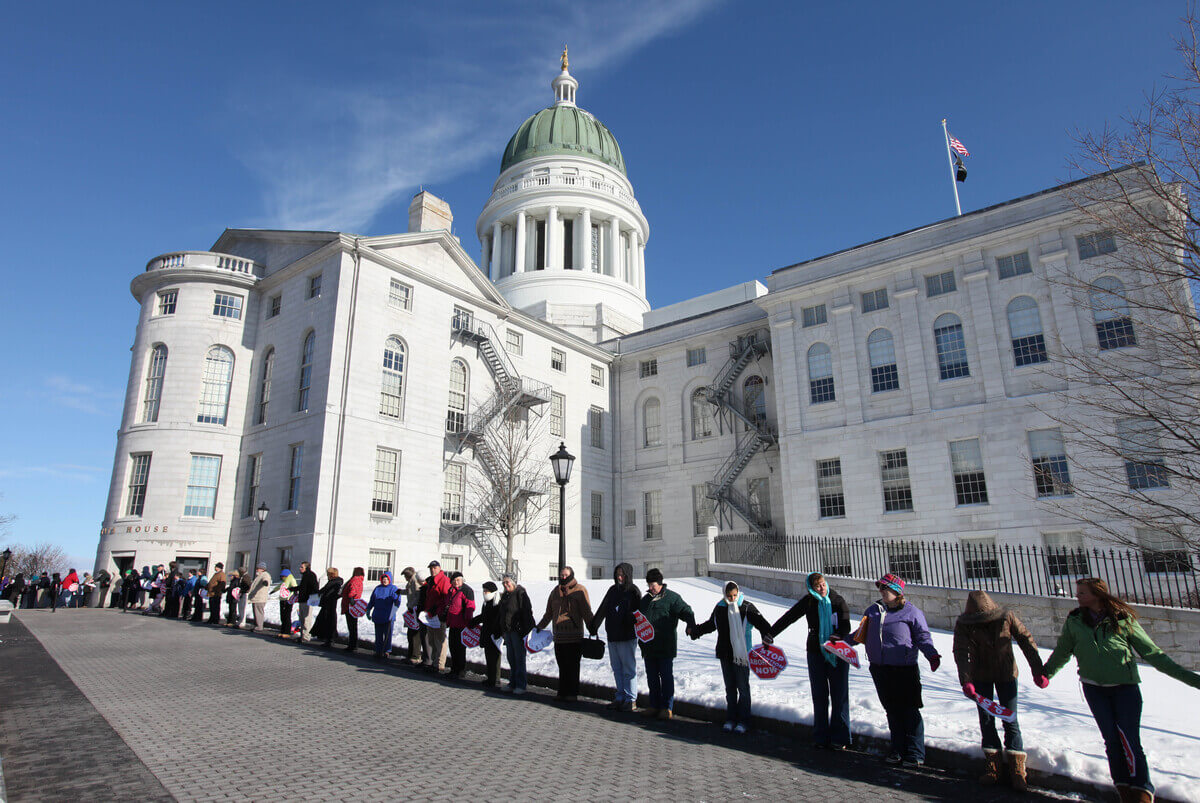 Anti-abortion protesters line outside the State House in Augusta.