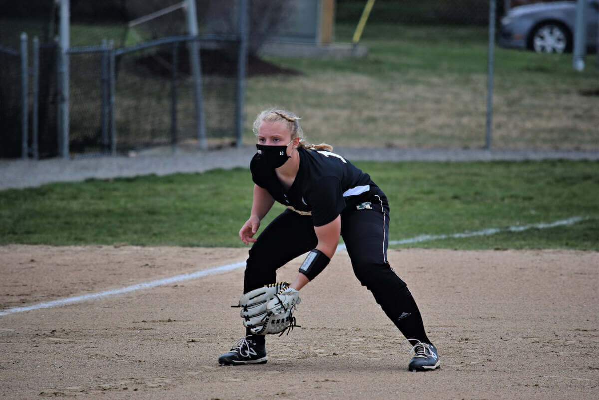 A softball player prepares to make a catch