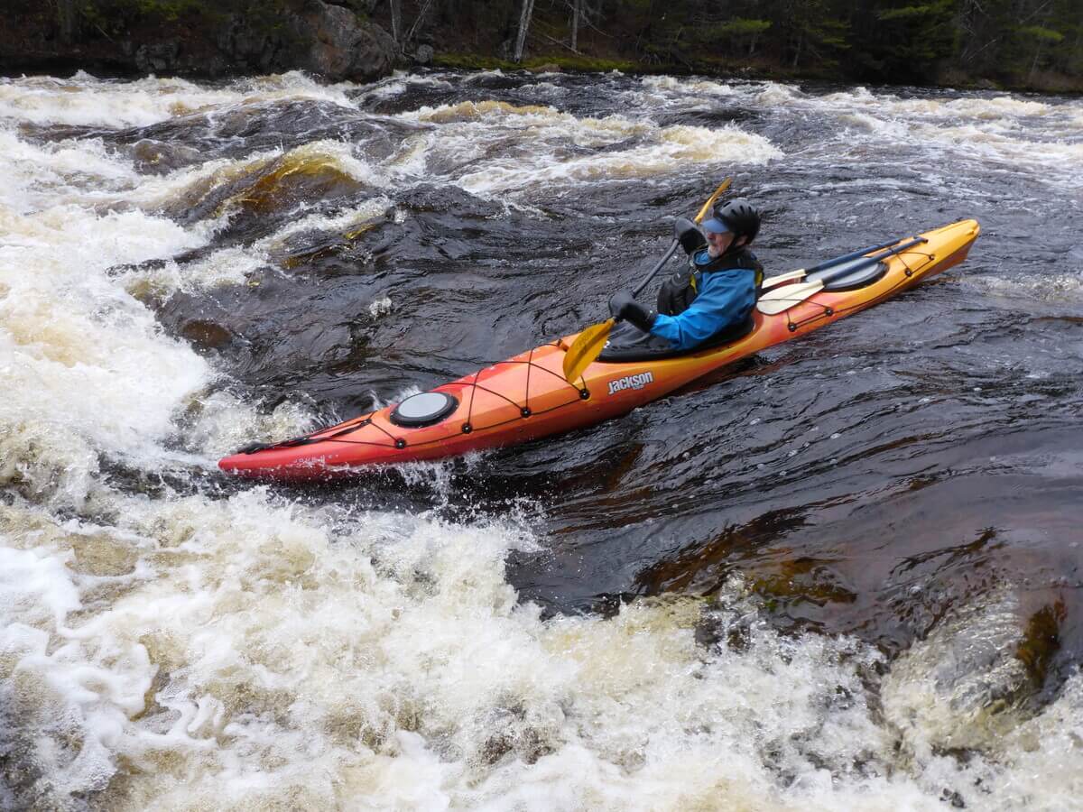 A kayaker goes down a waterfall