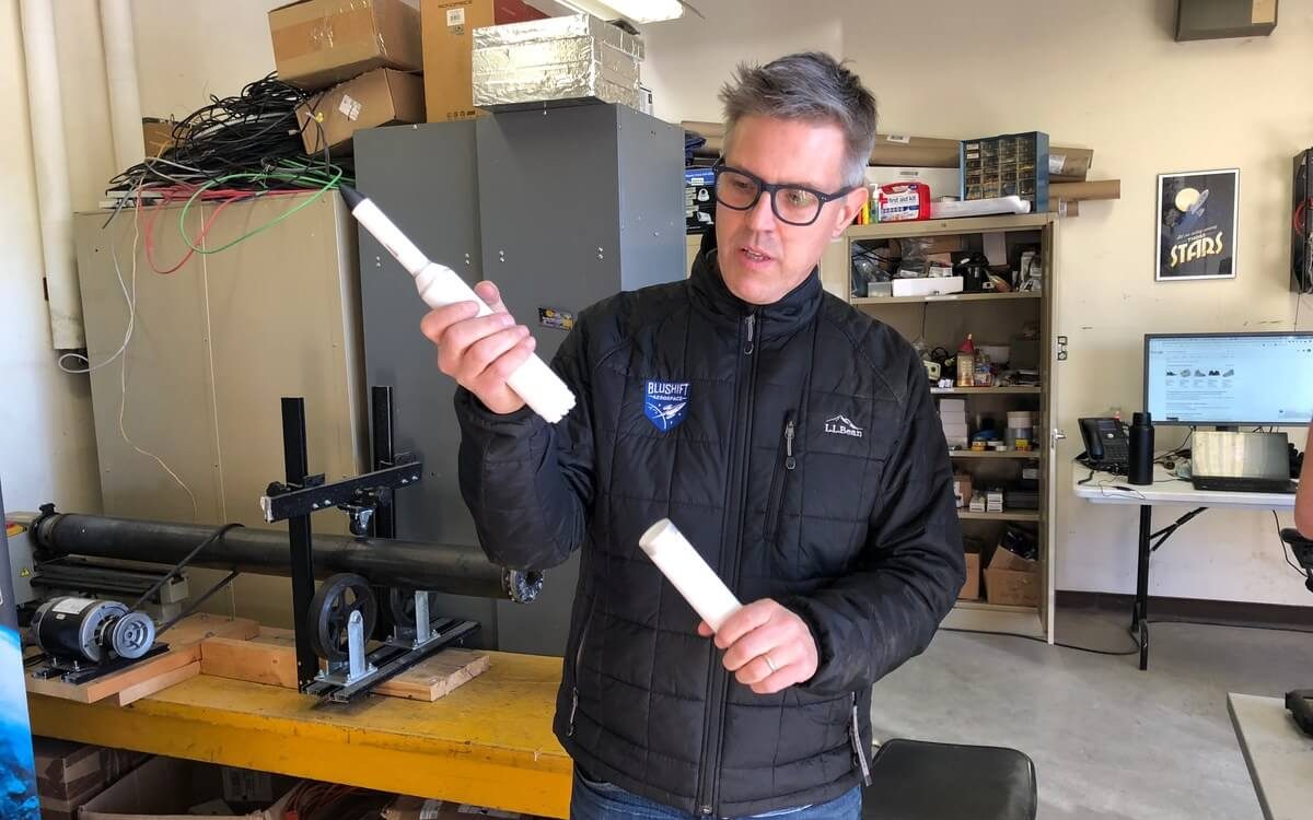 A man holds a model rocket