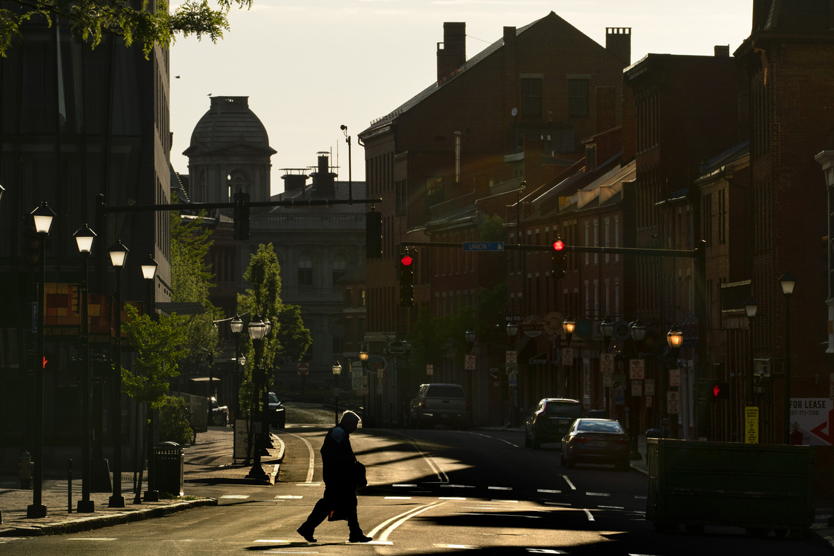 A man crosses Portland's Fore Street in the early morning.