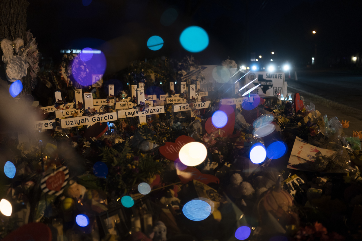 White crosses are lined up at night.