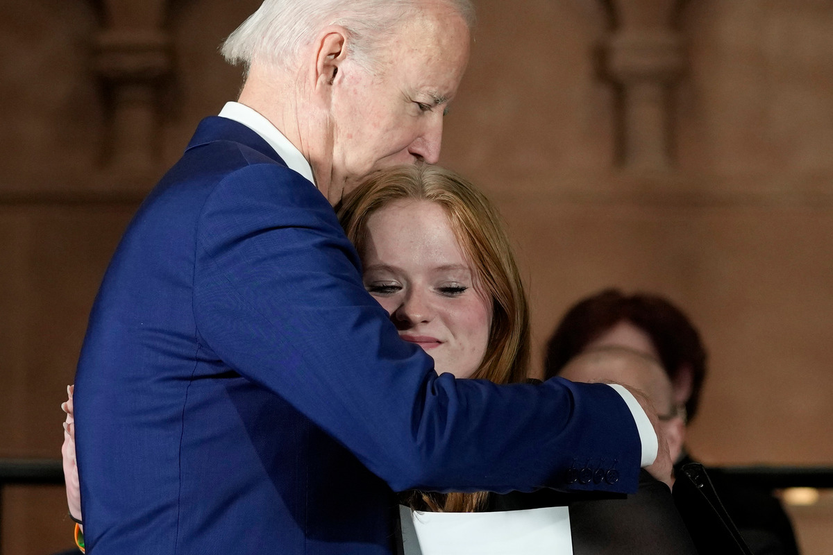 President Joe Biden hugs a survivor of the 2012 Sandy Hook school shooting.