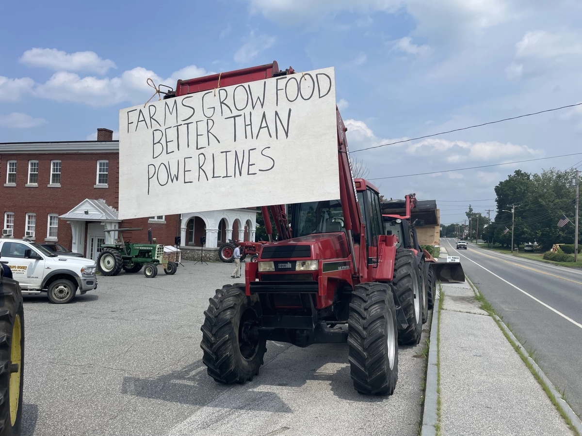 Two dozen farmers protested outside a meeting that developer LS Power was holding to discuss the project.