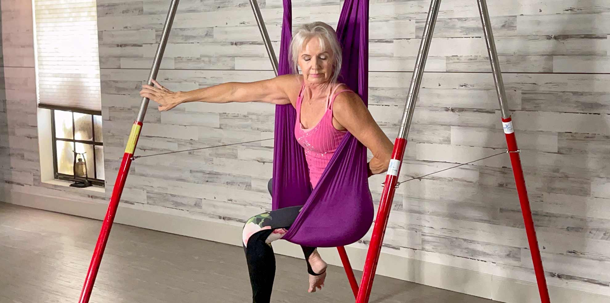 woman using silks to support yoga positions