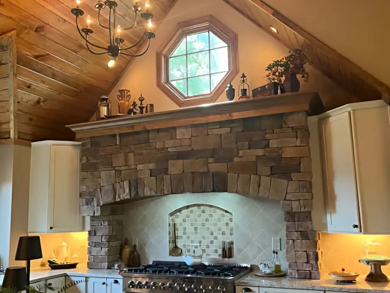 Vaulted wood-plank ceiling over a stone range hood with dormer window