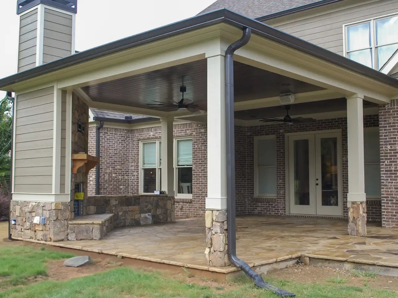Covered patio with stacked stone columns and half walls