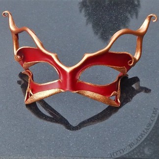 sculpted leather mask with abstract cat motif and intricate shaping. Shown in scarlet red and bronze