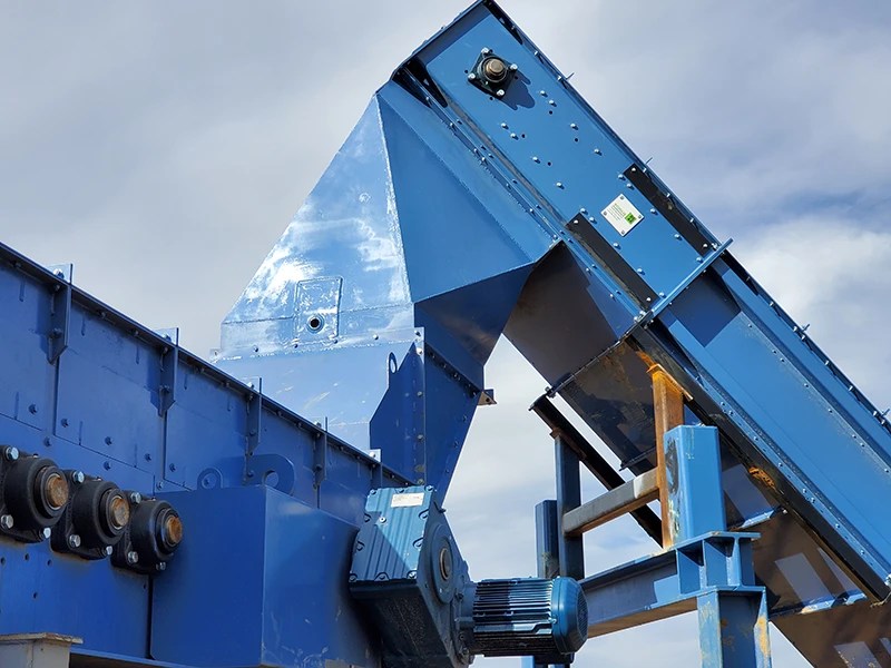 A drag chain conveyor feeds a disc screener.