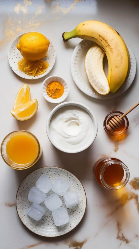 ingredients for a golden smoothie displayed on a white marble countertop