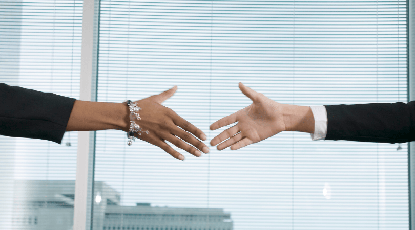 Two women shaking hands