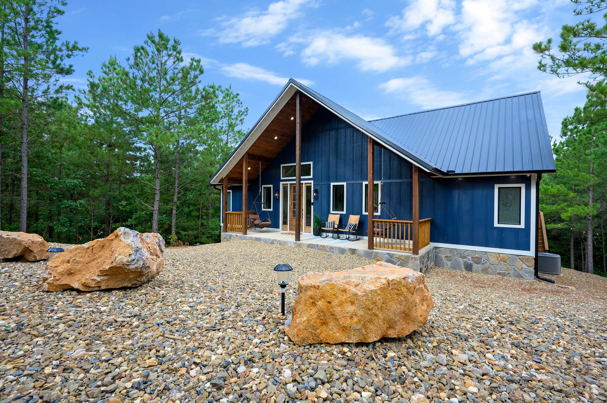 Front exterior of Beds, Boating & Beyond cabin surrounded by pine trees