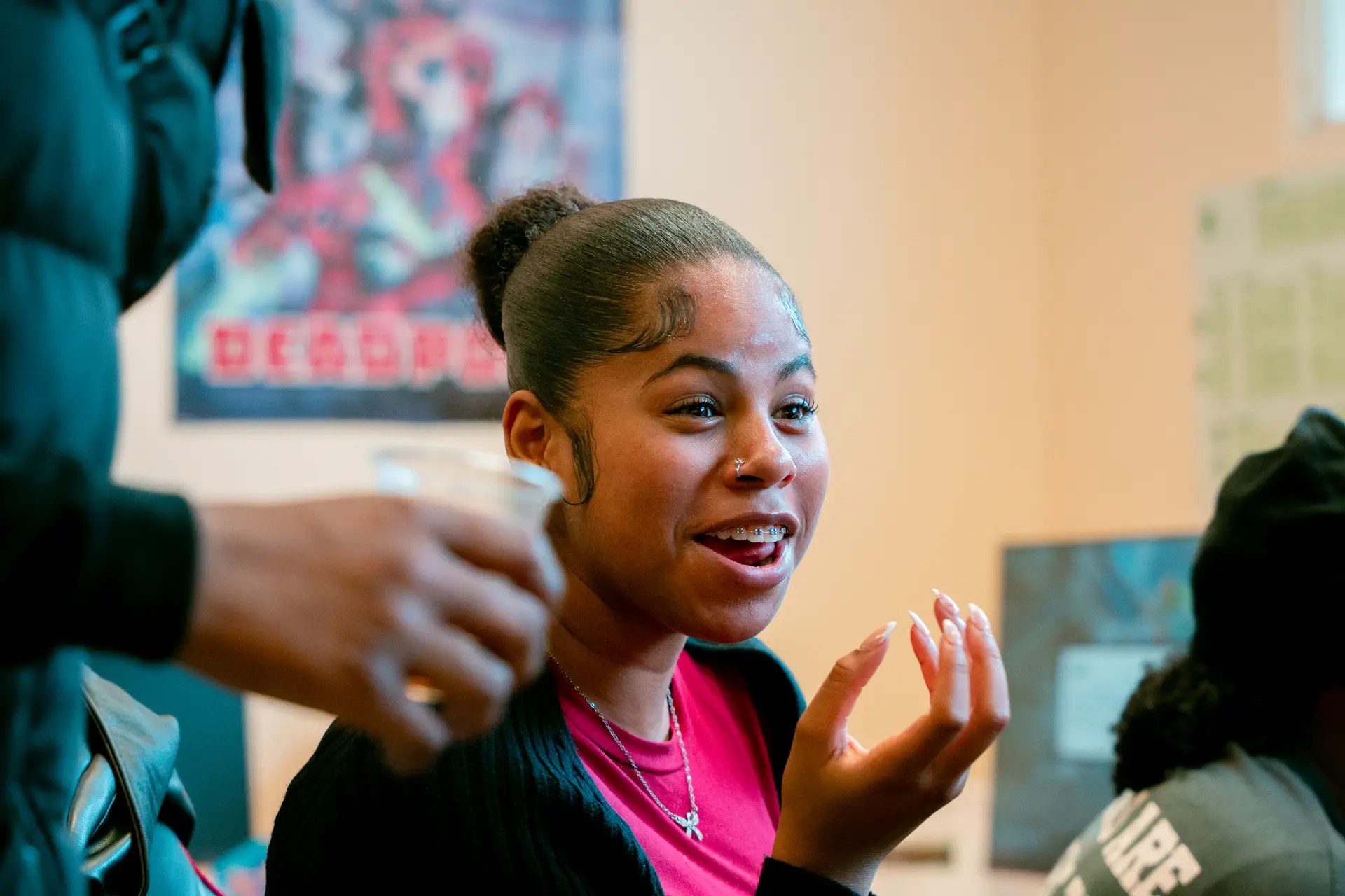 Young woman smiling and engaging during the Bee N Spired Gaming Takeover youth event.