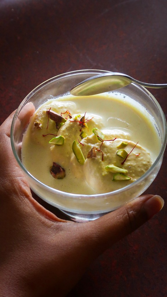 Taking a scoop out of a cup of Vegan Ras Malai