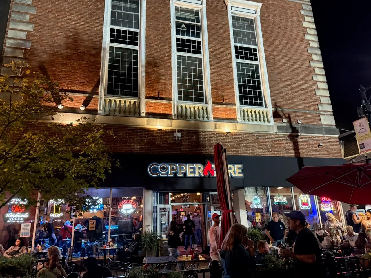 at night outside a brick building with lights on it. a restaurant.