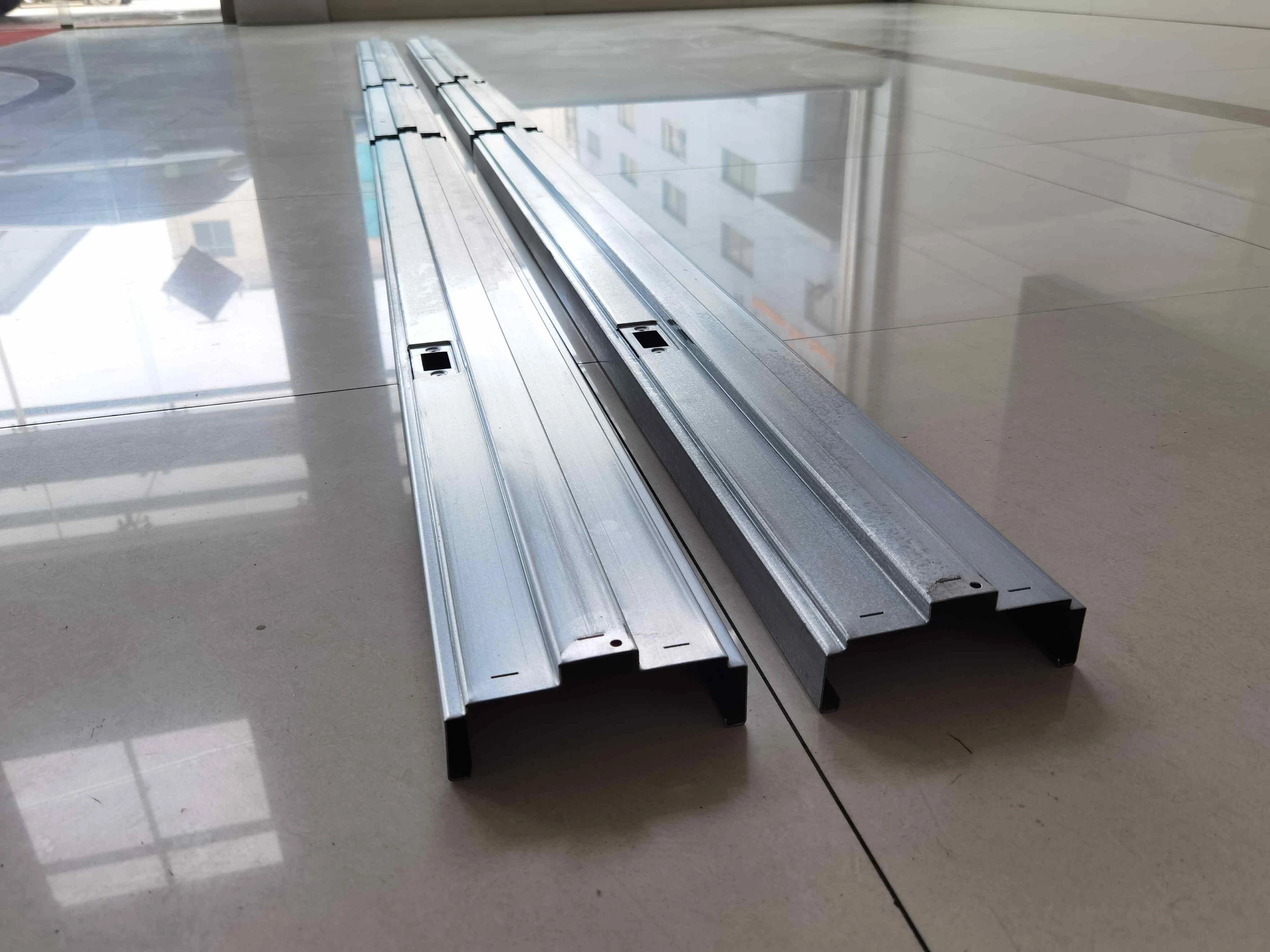 Finished metal door frame samples with precise cuts and punched holes, manufactured by a door frame roll forming machine.