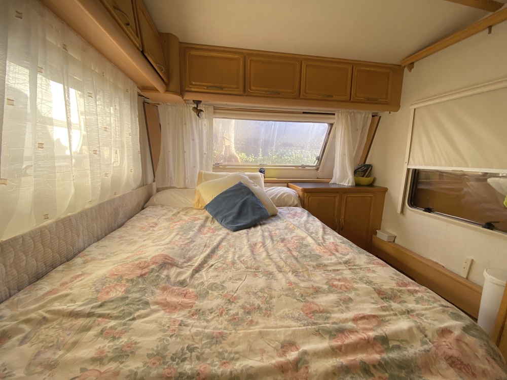 A double bed in a touring caravan on Camping Armanello Campsite in Benidorm