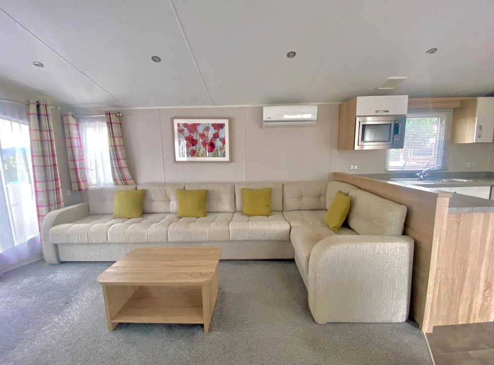 A large cream sofa in a static caravan being sold in Murcia, Spain