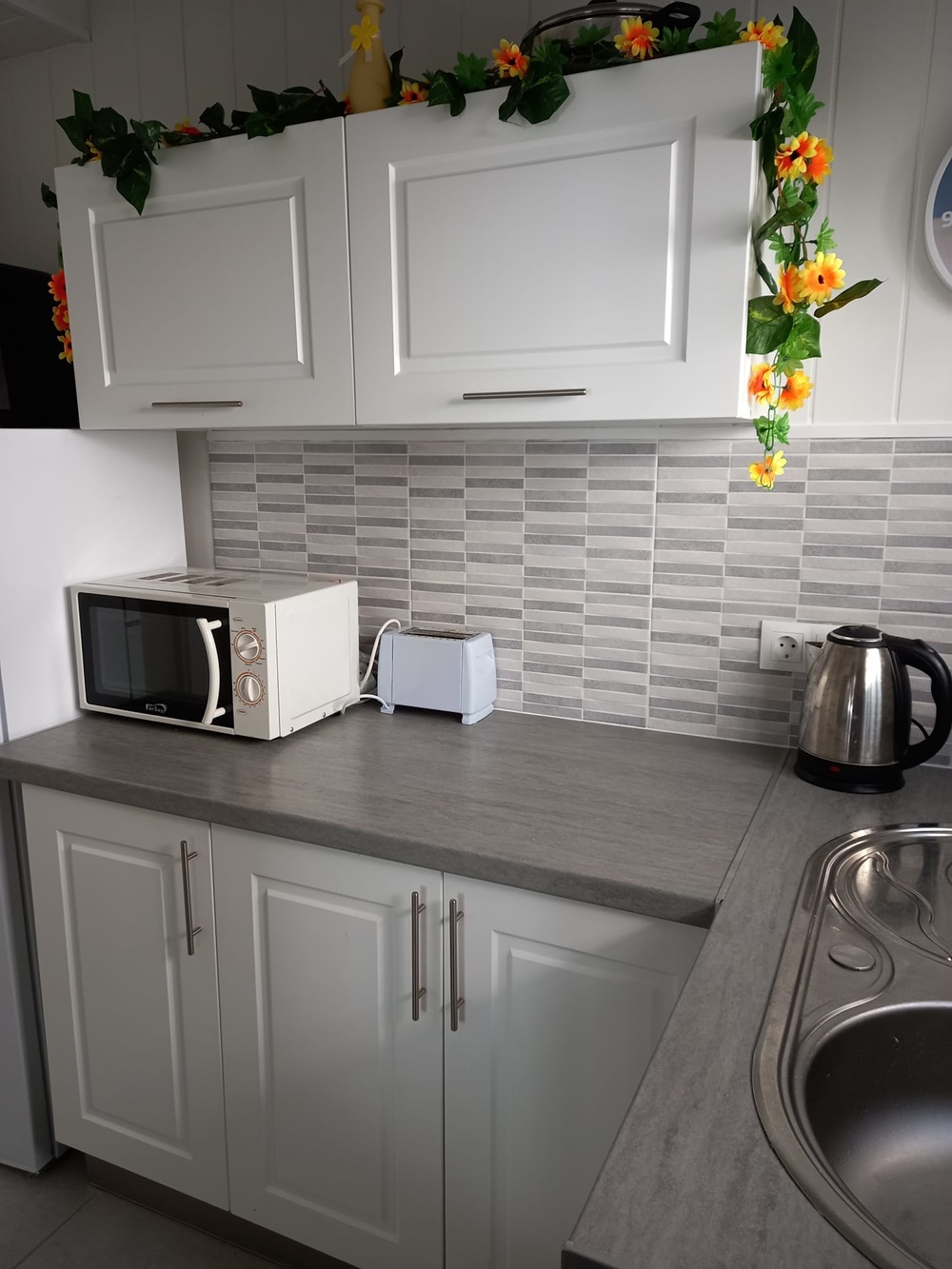 A kitchen in a caravan on Camping Villasol Campsite in Benidorm