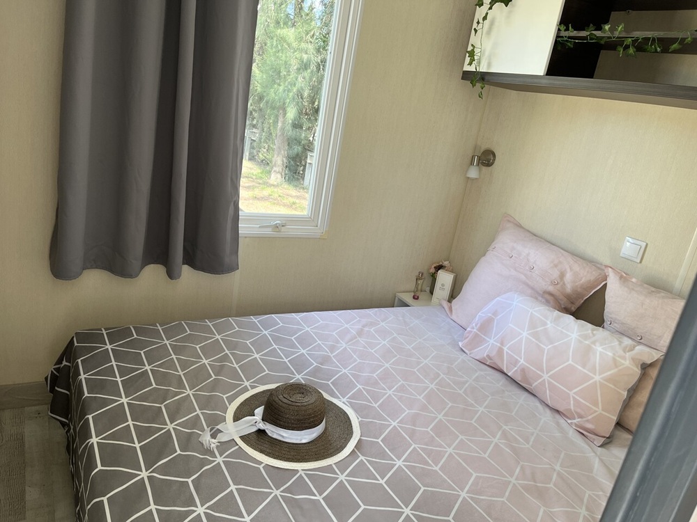 A double bed in a mobile home for sale in El Rocio