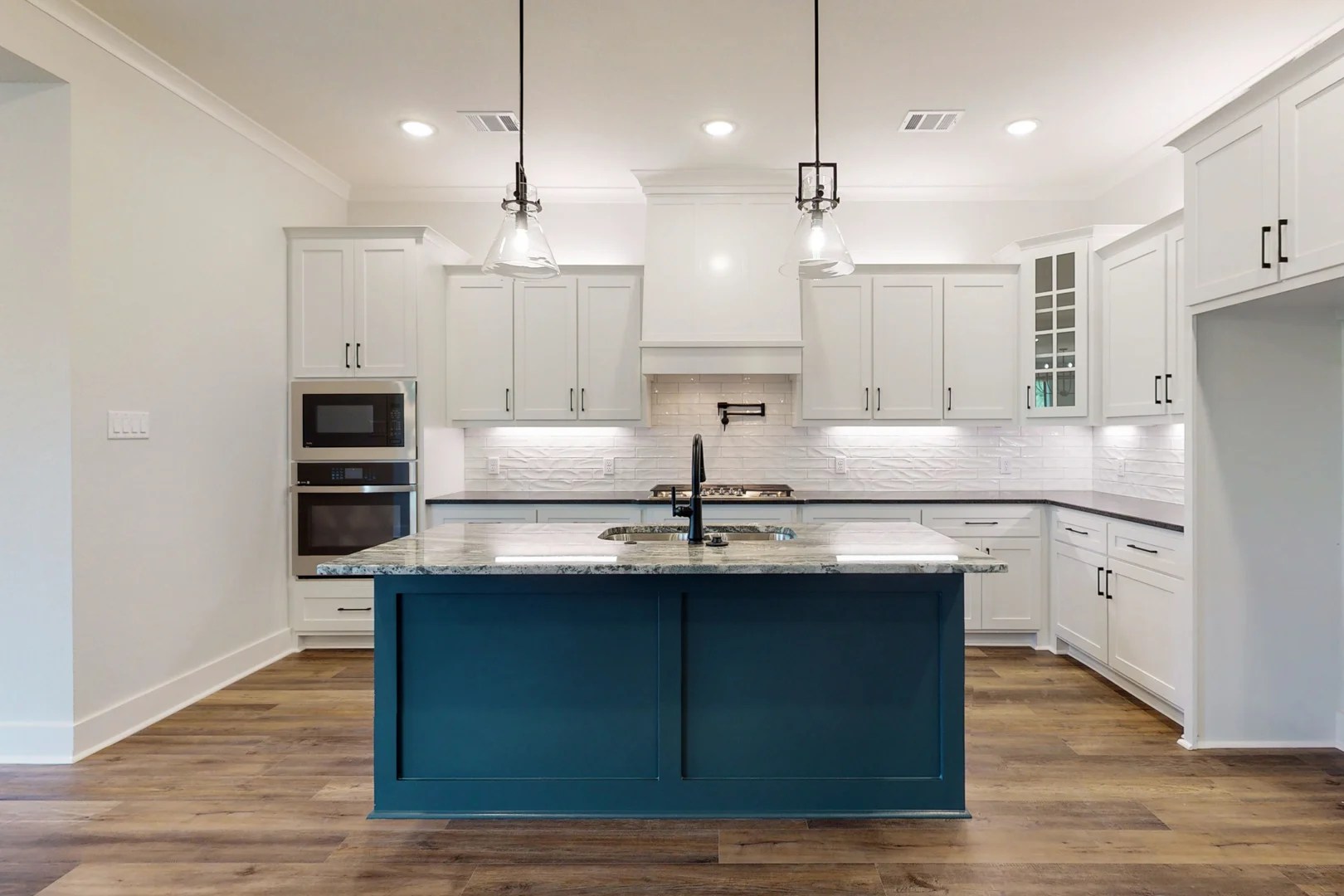 blue kitchen island and white cabinetry