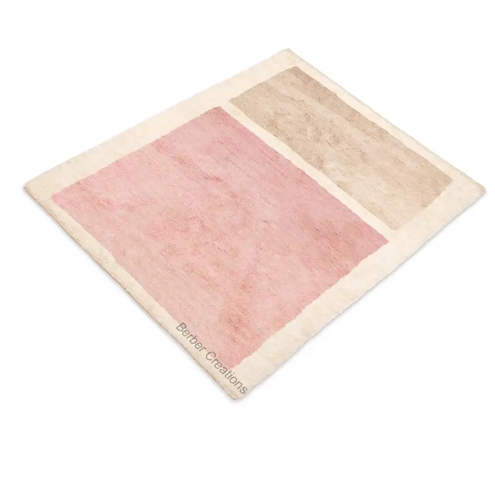Flat lay Minimalist Beni Ourain SAKURA rug with soft pink and beige color blocks on an off-white wool background