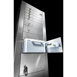 Modern metal mailbox unit with multiple compartments, one door open revealing mail inside, against a dark background.