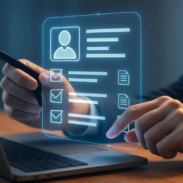 Man digitally filling online application form on laptop at night.