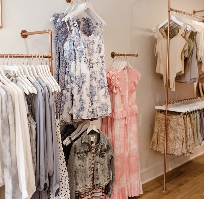 Dresses and blouses on display in a clothing store