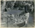 2007.034.010-Foundry-employees-1950-LG Photograph of three employees working on a factory floor. The photo is stamped with the date October 1, 1950. This is likely at Wheland Foundry, which was established in Athens, Tennessee, in 1866, and moved to Chattanooga in 1873, where the plant built sawmill machinery and oil well drilling equipment. During World War I and World War II, they made anchor windlasses for ships as well as guns and shells.
