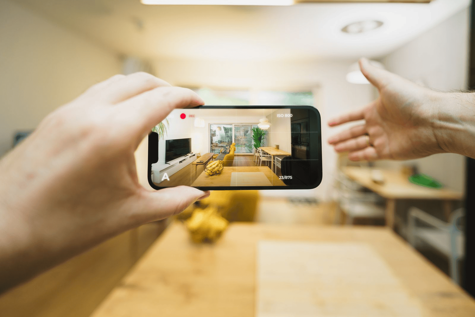 Agent reviewing AI-altered listing photos on a phone