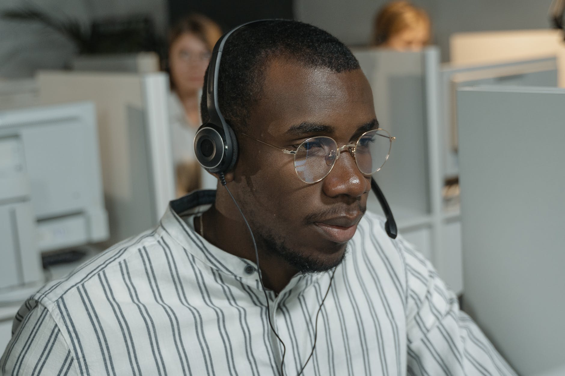 man in white and black striped button up shirt wearing black headphones