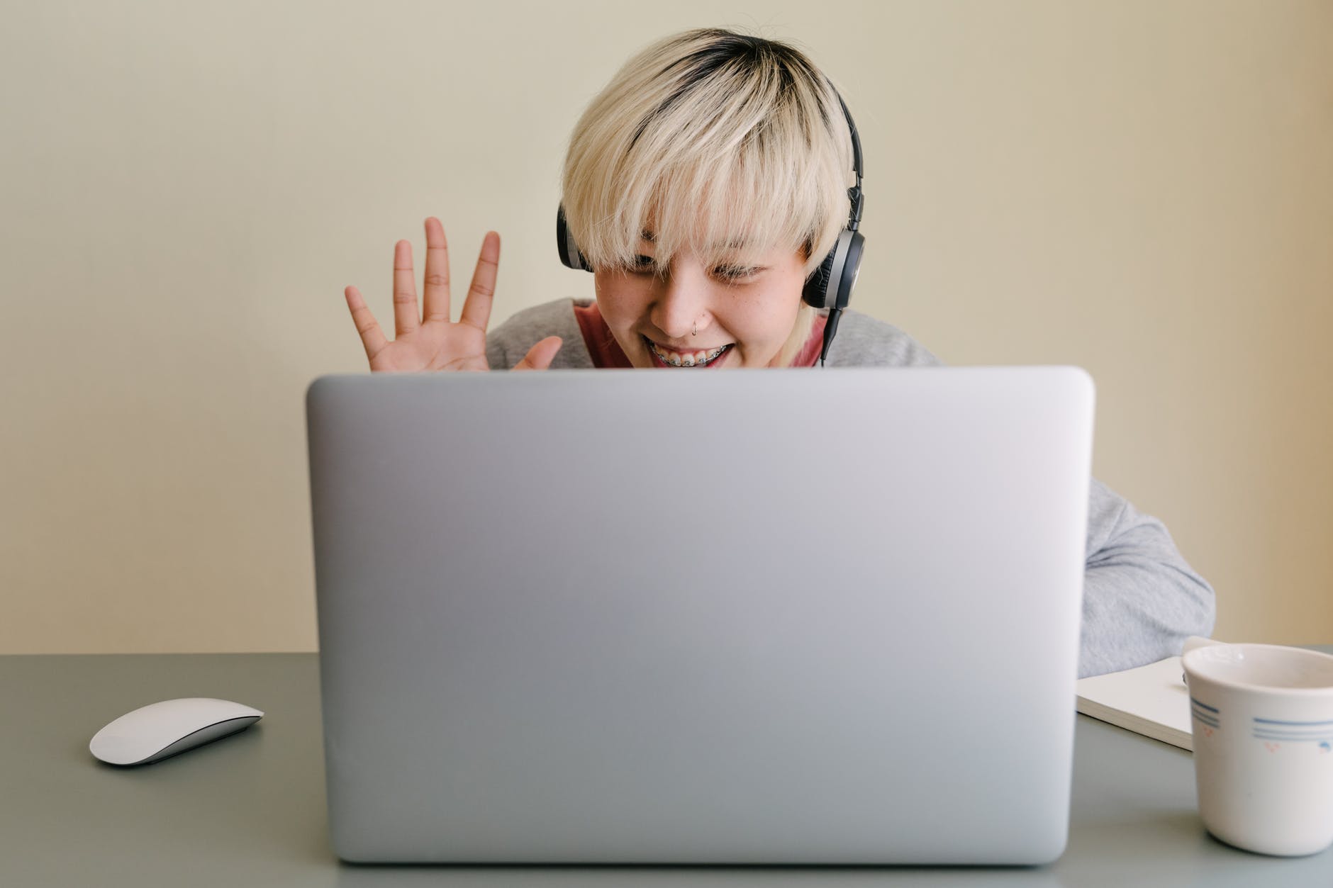 happy young woman having video call via laptop