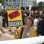 Judi with a sign that reads choice, not force