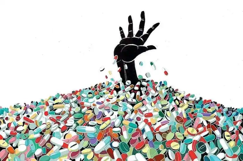hand coming up as drowning out of a pile of pills Psychiatric drugs as agents of trauma