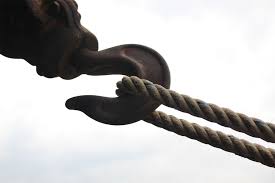 a hook with a rope getting to the heart of the knot which is the hook