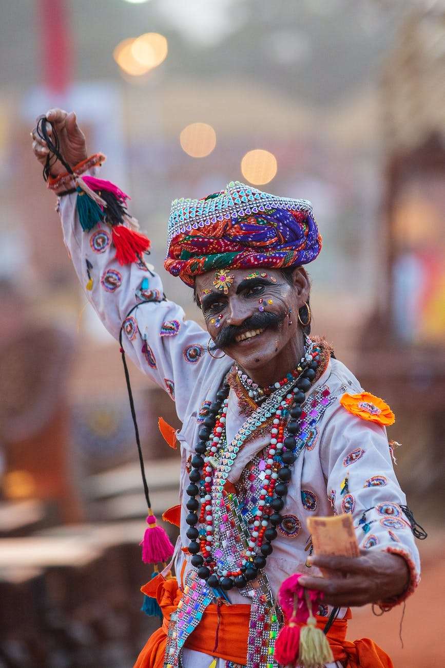 man wearing make up and colored dress while dancing