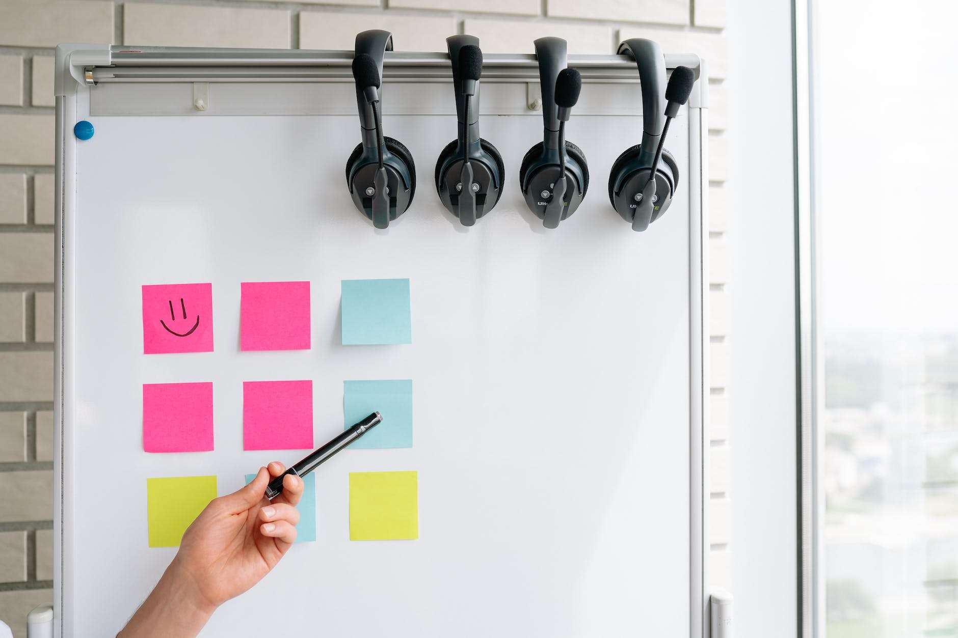 whiteboard with sticky notes and headsets