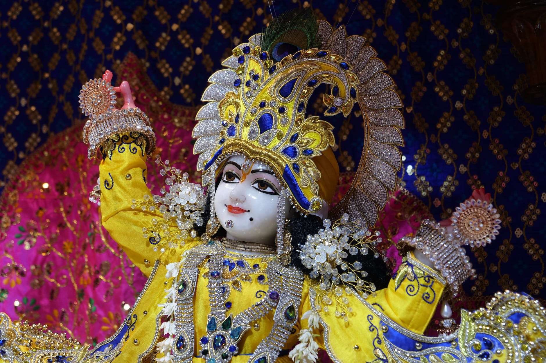 the statue of deity krishna with lavish decorations