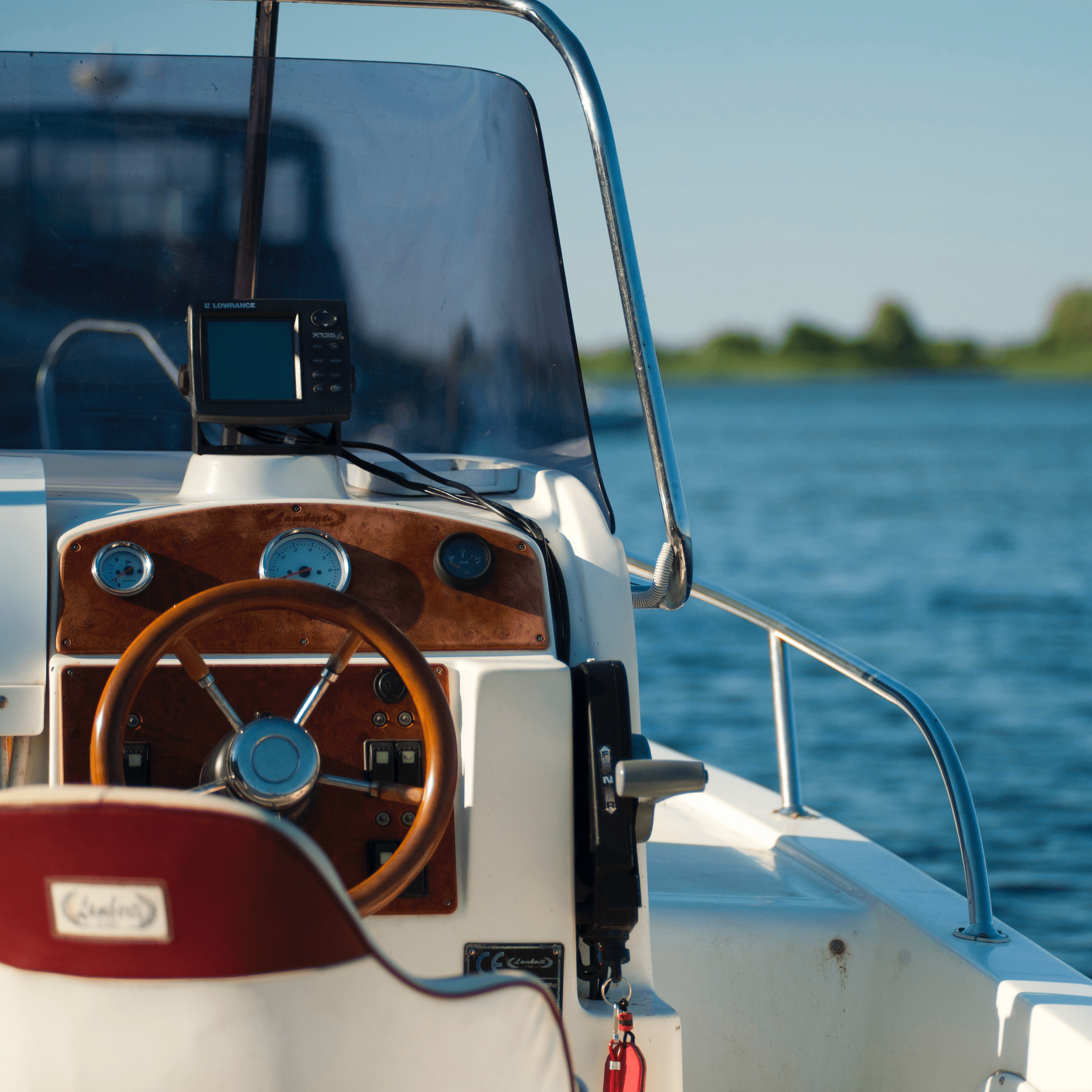 Close up of the captains seat on a boat with the water in the background