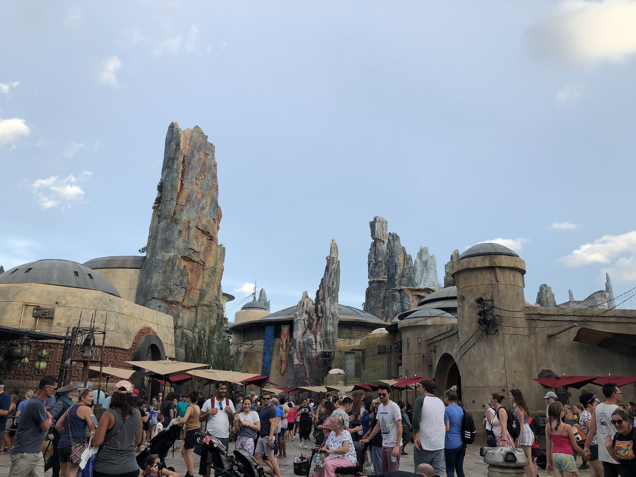 people walking around in the town in the galaxy edge park